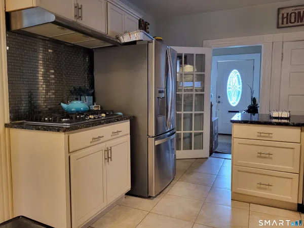 a kitchen with a refrigerator and cabinets