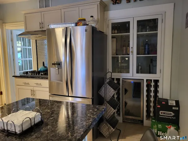 a kitchen with stainless steel appliances granite countertop a refrigerator and a stove