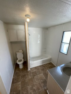 1265 North Corbonville Road, Unit 100 Price, UT 84501 - Photo 5 of 10 Bathroom featuring a stall shower, vanity, and a textured ceiling