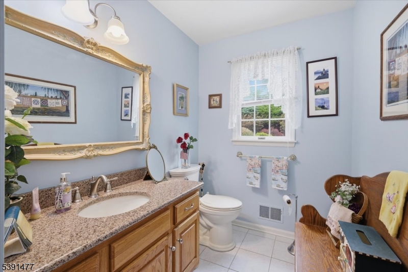 42 Copper Penny Road Flemington, NJ 08822 - Photo 20 of 39 a bathroom with a granite countertop toilet a sink and a mirror