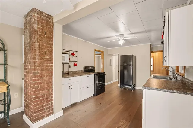 a kitchen with stainless steel appliances granite countertop a refrigerator a stove and a sink