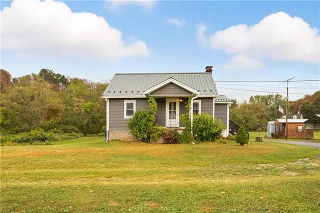 a front view of house with yard and green space