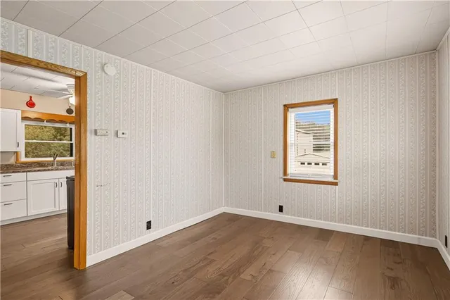 a big room with wooden floor and windows