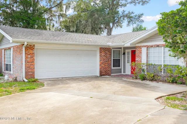 a view of a house with a yard and garage