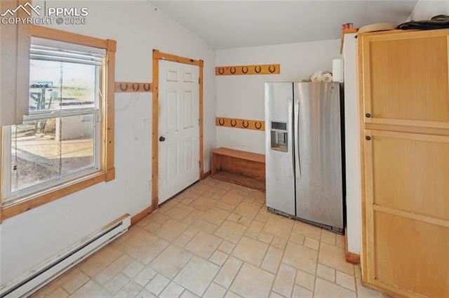 16830 Finch Road Colorado Springs, CO 80928 - Photo 21 of 49 If you truly enjoy the acreage, you'll definitely want this mud room, which has a walk-way to the largest garage/shop, as well as a nice back patio for sitting around the firepit