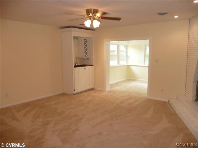 8127 Lethbridge Road Richmond, VA 23235 - Photo 11 of 12 Interior Space/Layout - The Sunroom can be Accessed From the Family Room. Natural Light Floods the Area and New Carpet and Paint Compliment This Home. The New Wetbar Features Everything You Need For Entertaining. The Fireplace is Custom Built & is Wonderful for Chilly Nights.