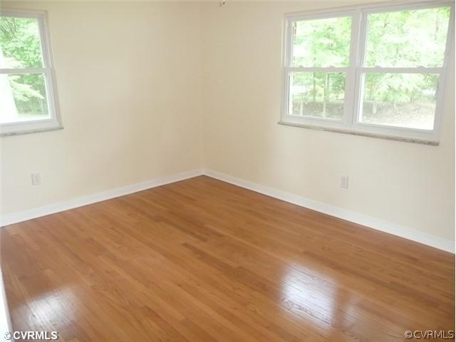 8127 Lethbridge Road Richmond, VA 23235 - Photo 12 of 12 Bedroom - Gleaming Hardwood Floors, Built-in Cabinets, Double Closets and Newly Painted. Three Windows Allow Natural Light to Flood The Bedroom. The Natural Setting Outdoors is Relaxing and Peaceful.