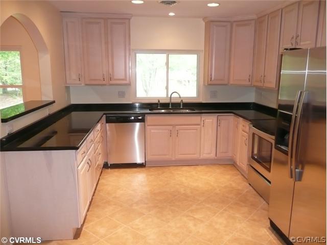 8127 Lethbridge Road Richmond, VA 23235 - Photo 2 of 12 Kitchen - This Kitchen Is a show stopper! Granite Counters, New Cabinets & Tile Floors, Sparkling Stainless Appliances, Granite Pass-Thru Bar & Window Overlooking Yard. Notice the Ample Amount of Natural Light & How Extra Attention was given to the Archway.