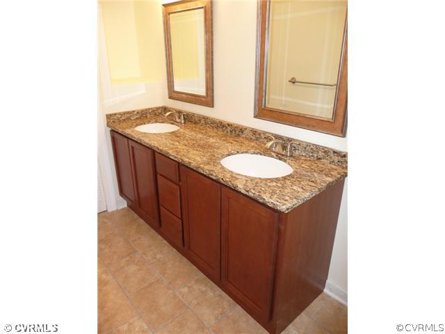 8127 Lethbridge Road Richmond, VA 23235 - Photo 7 of 12 Master Bath - Wonderfully Updated with Double Sink Vanity, New faucets, Hardware and Ceramic Tile Floors, New Mirrors and Lighting, Plenty of Raised Panel Cabinets, Freshly Painted and Sparkling New Throughout. What a Great Retreat After a Busy Day.