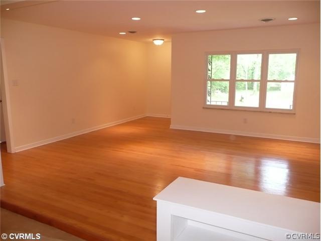8127 Lethbridge Road Richmond, VA 23235 - Photo 10 of 12 Living Room - What an Entrance! Everything is New...Recessed Lights, Windows, Floors, Paint, and Trim. Step down into the Family Room From Here. You will be Completely Amazed by the Workmanship in this Home.
