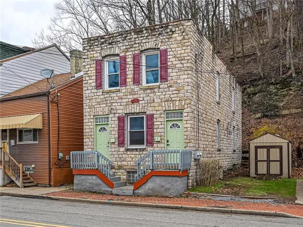 a front view of a house with stairs