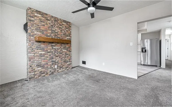 a view of an empty room with a ceiling fan