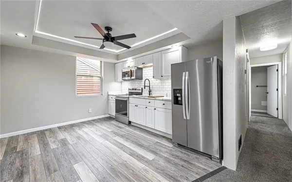 a kitchen with stainless steel appliances a refrigerator and a stove top oven