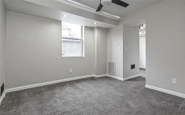 an empty room with windows and closet