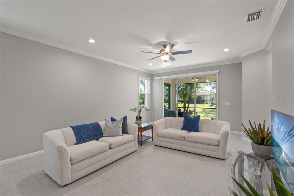 8605 Rain Song Road Sarasota, FL 34238 - Photo 12 of 52 a living room with furniture and a large window