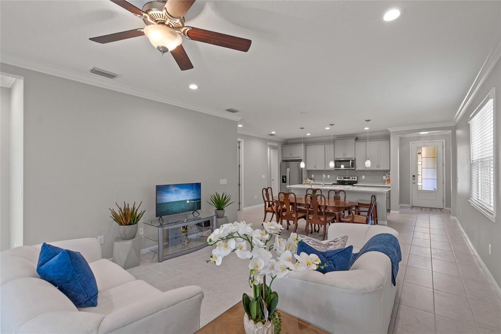 8605 Rain Song Road Sarasota, FL 34238 - Photo 13 of 52 a living room with furniture kitchen view and a chandelier