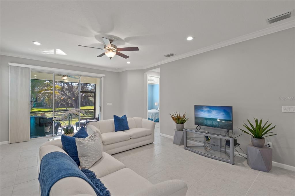 8605 Rain Song Road Sarasota, FL 34238 - Photo 13 of 52 a living room with furniture potted plant and a large window