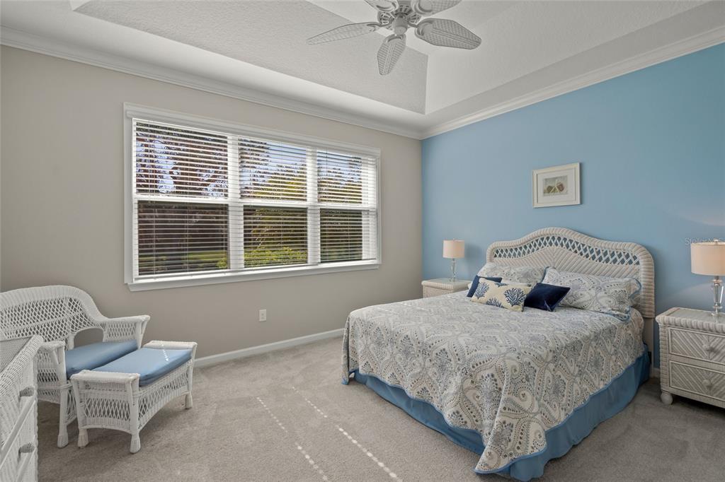 8605 Rain Song Road Sarasota, FL 34238 - Photo 16 of 52 a bedroom with a bed and chair