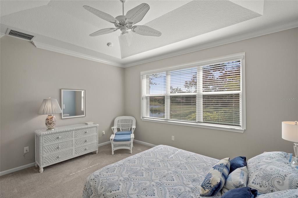 8605 Rain Song Road Sarasota, FL 34238 - Photo 18 of 52 a bedroom with a bed and a window