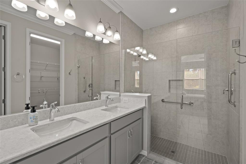 8605 Rain Song Road Sarasota, FL 34238 - Photo 19 of 52 a bathroom with a sink double vanity granite tub shower and a mirror