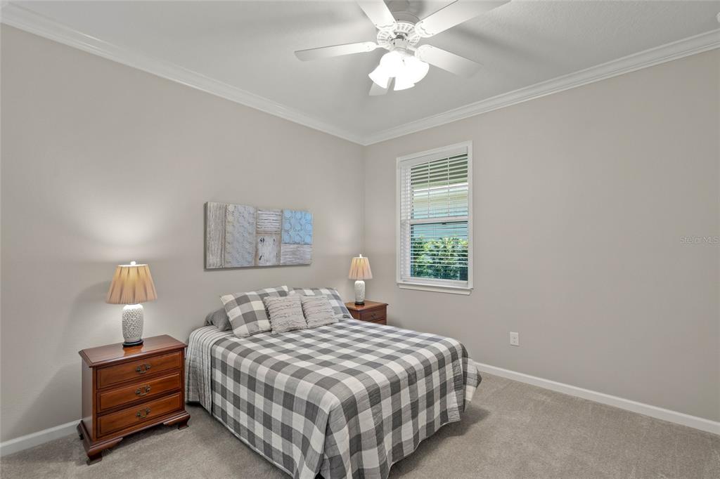 8605 Rain Song Road Sarasota, FL 34238 - Photo 22 of 52 a bedroom with a bed and a window