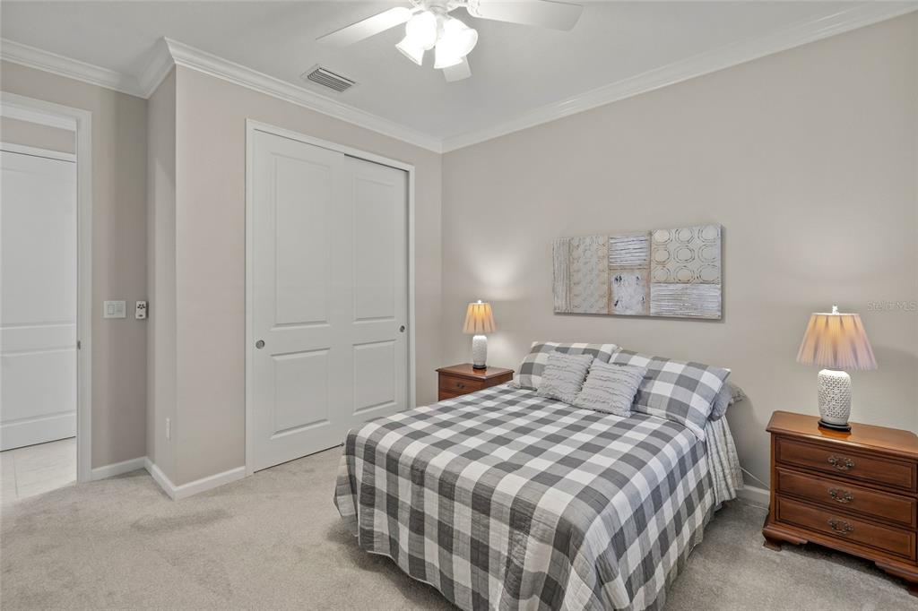 8605 Rain Song Road Sarasota, FL 34238 - Photo 23 of 52 a bedroom with a bed and a chandelier
