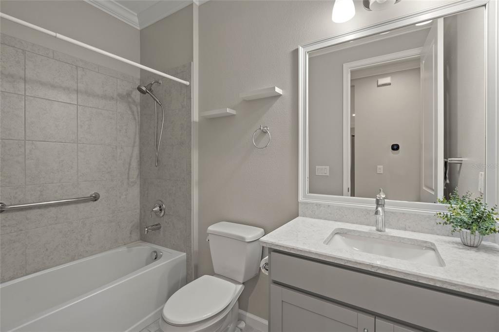 8605 Rain Song Road Sarasota, FL 34238 - Photo 24 of 52 a bathroom with a sink toilet a vanity and shower