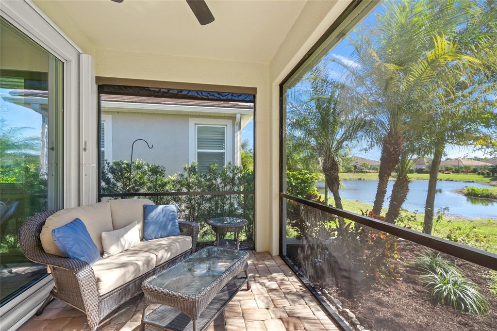 8605 Rain Song Road Sarasota, FL 34238 - Photo 26 of 52 a view of a porch with furniture and a yard