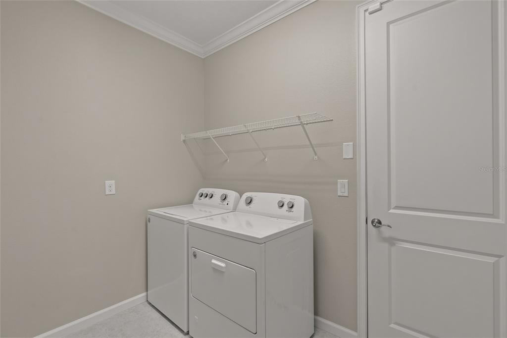 8605 Rain Song Road Sarasota, FL 34238 - Photo 26 of 52 a utility room with dryer and washer