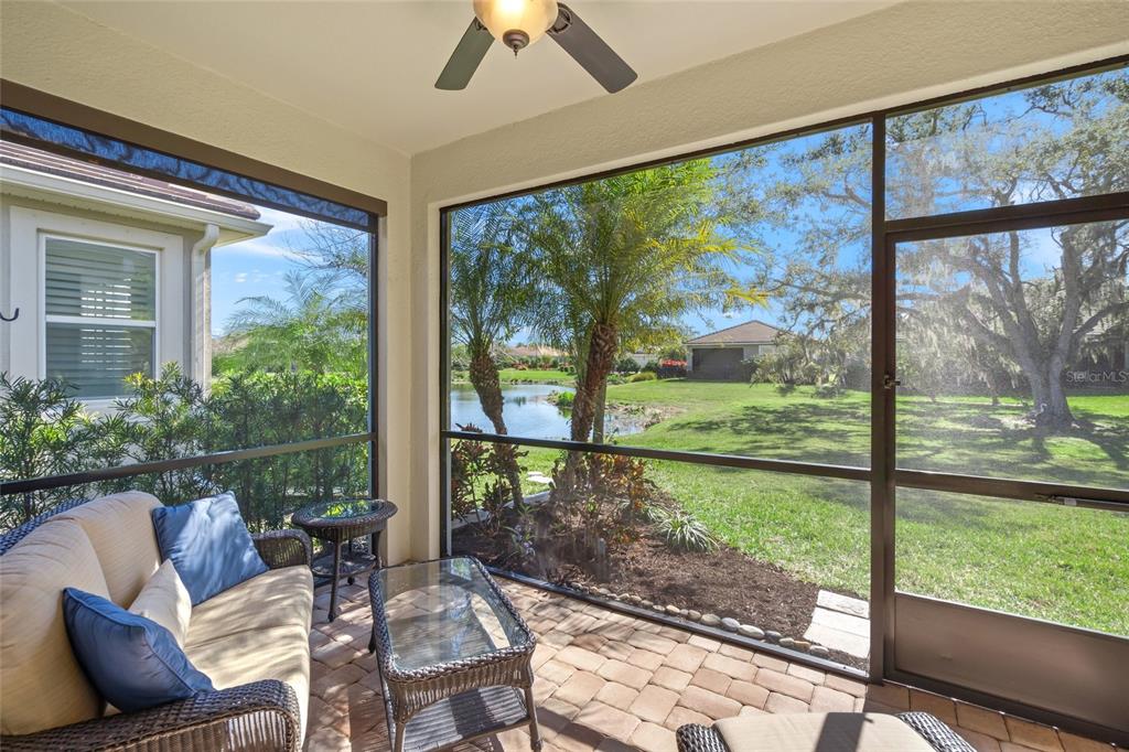 8605 Rain Song Road Sarasota, FL 34238 - Photo 27 of 52 a living room with large windows and couches