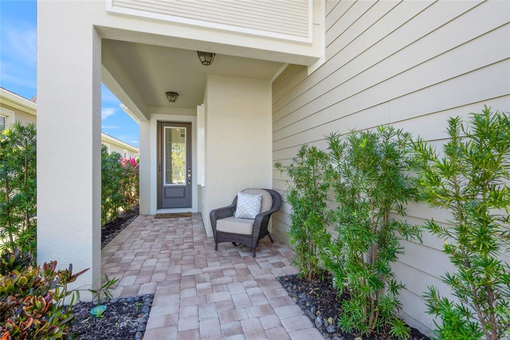 8605 Rain Song Road Sarasota, FL 34238 - Photo 3 of 52 a view of a chair and table in backyard of the house