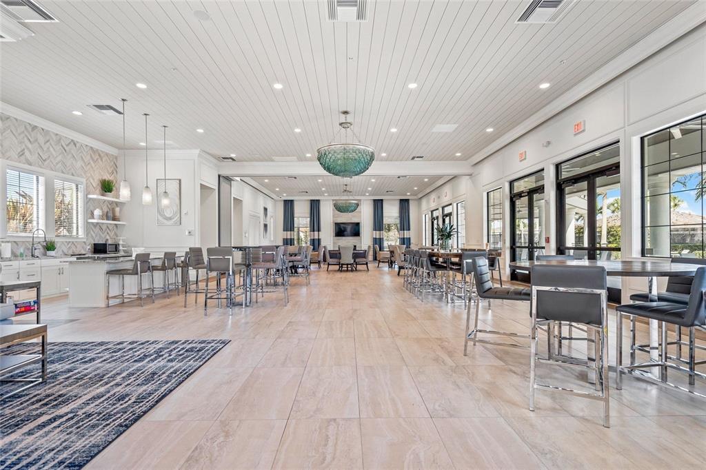 8605 Rain Song Road Sarasota, FL 34238 - Photo 32 of 52 an outdoor space with lots of white furniture a rug and a chandelier