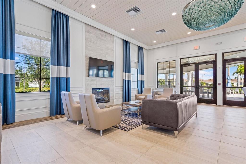 8605 Rain Song Road Sarasota, FL 34238 - Photo 33 of 52 a living room with furniture a fireplace and a large window