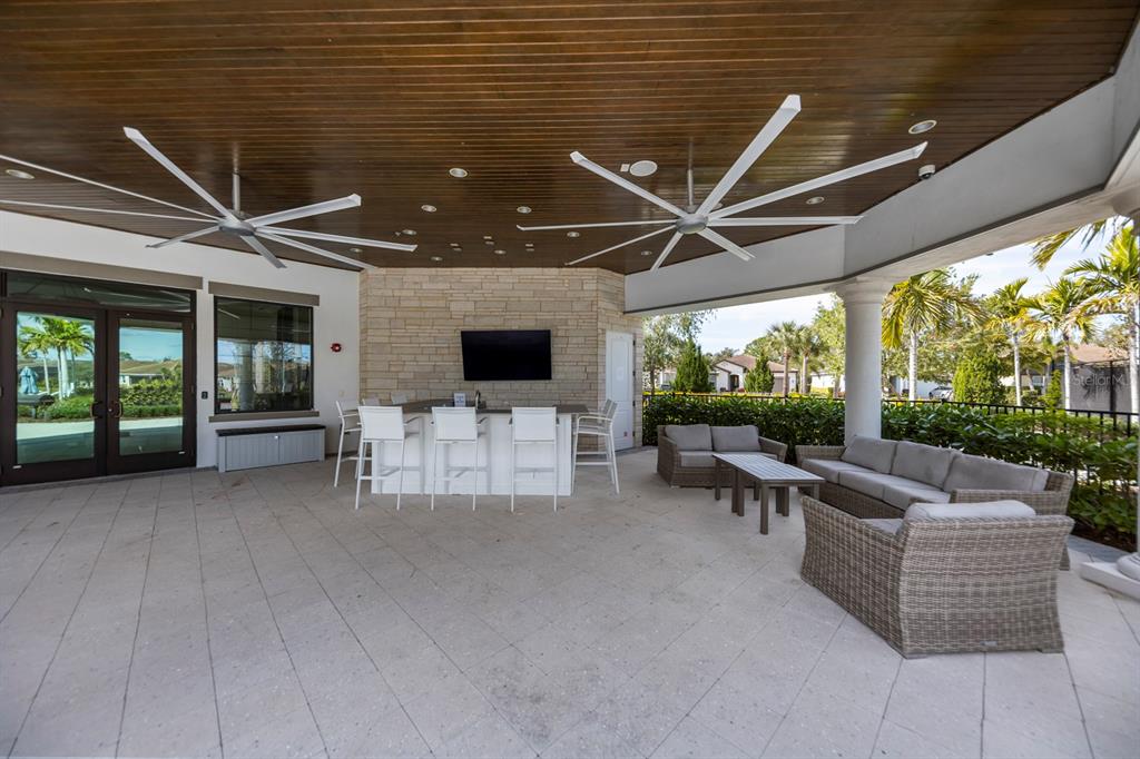 8605 Rain Song Road Sarasota, FL 34238 - Photo 42 of 52 a living room with furniture and a flat screen tv