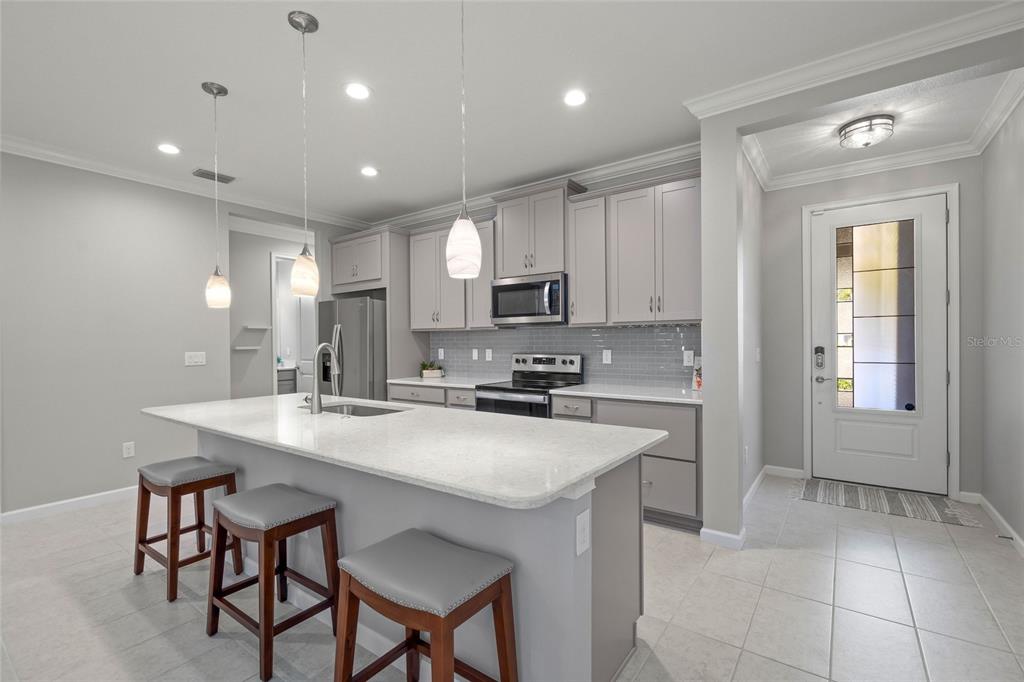 8605 Rain Song Road Sarasota, FL 34238 - Photo 5 of 52 a kitchen with counter space cabinets and appliances