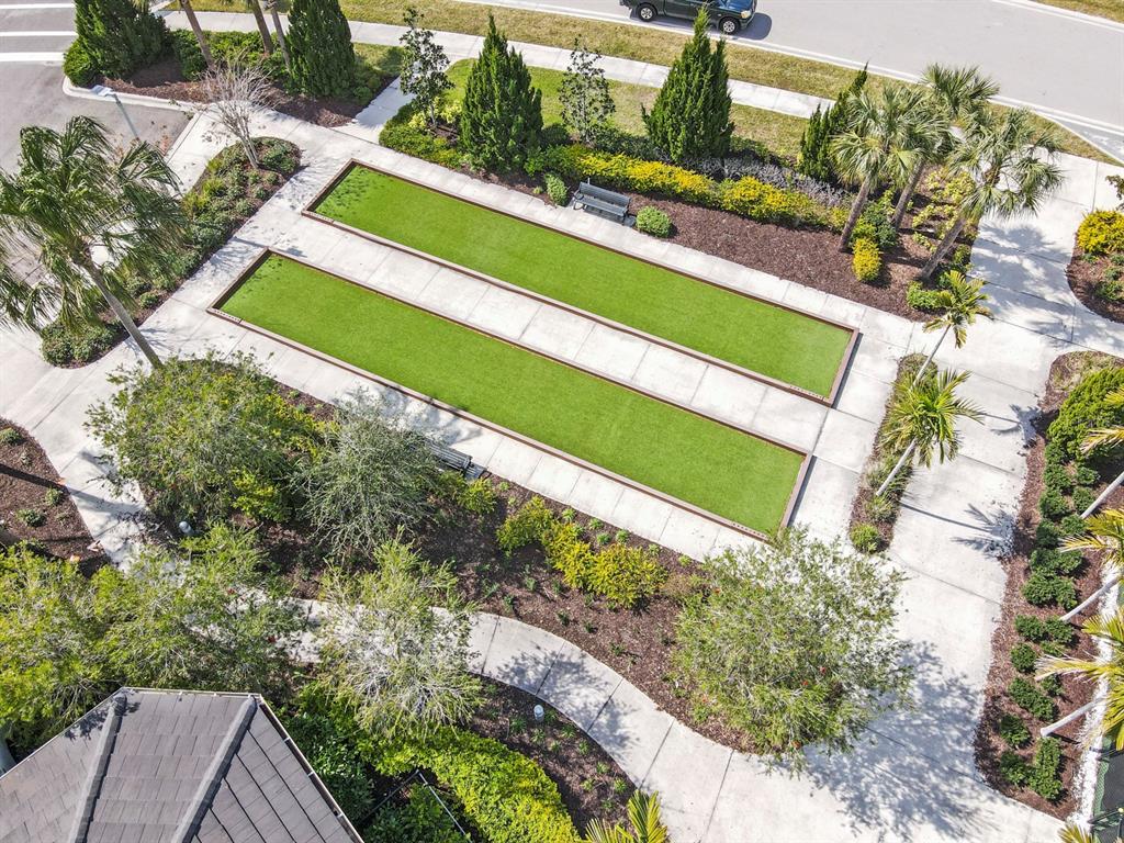 8605 Rain Song Road Sarasota, FL 34238 - Photo 51 of 52 a view of a yard with a bench and trees