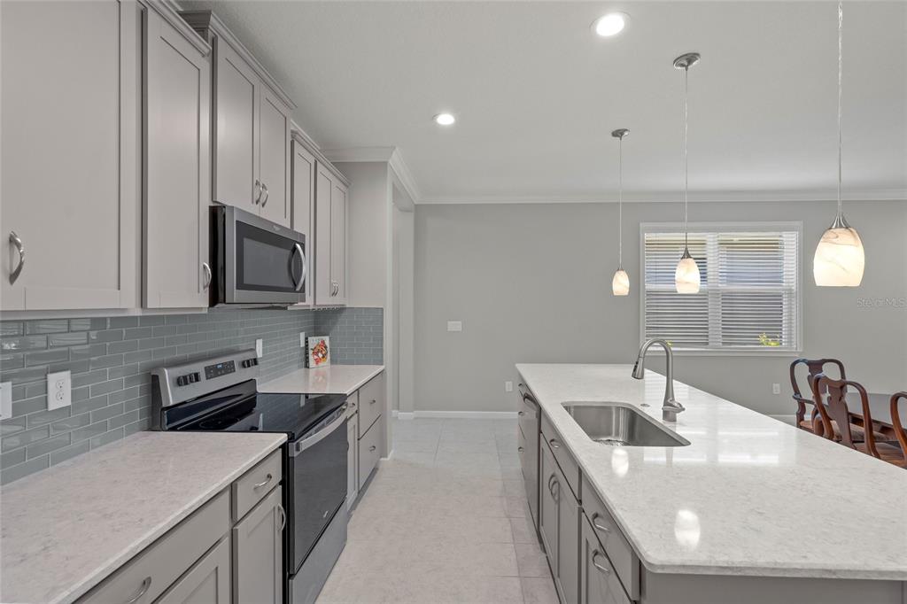 8605 Rain Song Road Sarasota, FL 34238 - Photo 6 of 52 a kitchen that has a sink and a stove in it