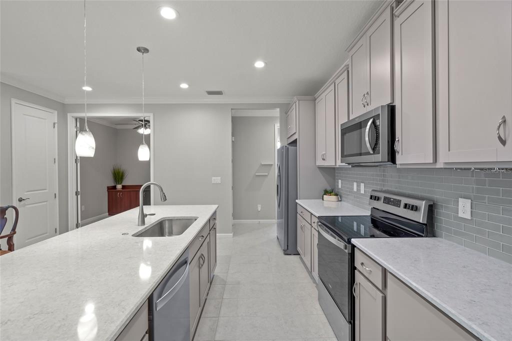 8605 Rain Song Road Sarasota, FL 34238 - Photo 7 of 52 a kitchen with stainless steel appliances granite countertop a sink stove and refrigerator