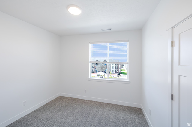 4727 South 690th West, Unit W301 Mapleton, UT 84664 - Photo 5 of 16 Recessed ceiling lighting, window with blinds, panel door, and carpeted flooring