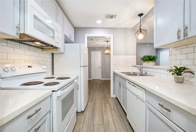 a kitchen with a stove and a white cabinet