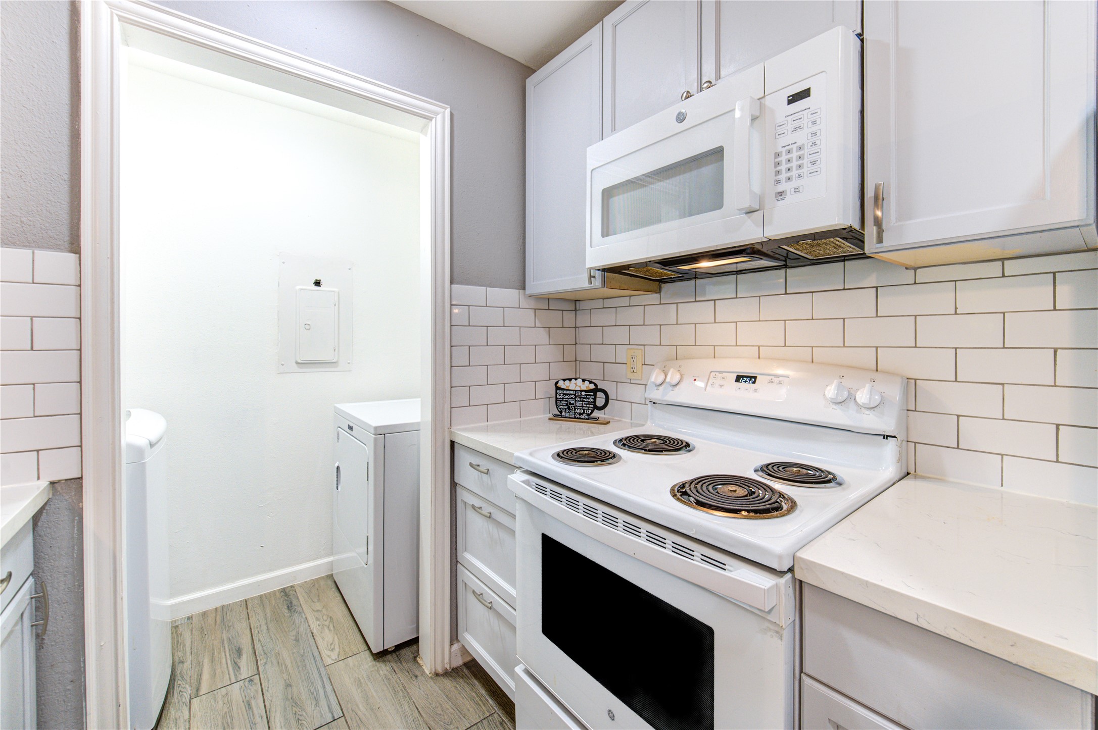3929 Tanglewilde Street, Unit 3929 Houston, TX 77063 - Photo 13 of 44 a kitchen with a stove and a white cabinet