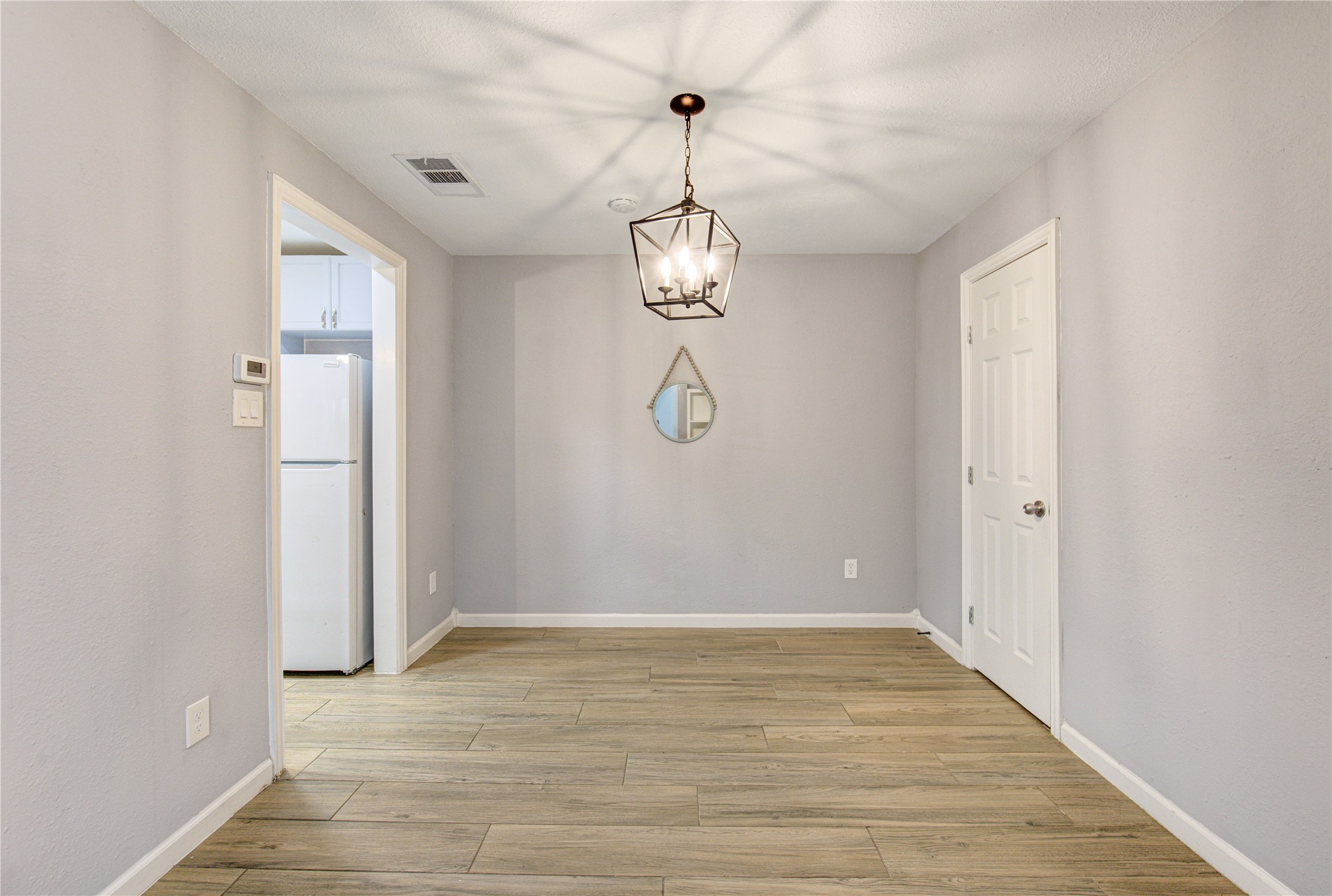 3929 Tanglewilde Street, Unit 3929 Houston, TX 77063 - Photo 21 of 44 a view of a room with wooden floor and white walls