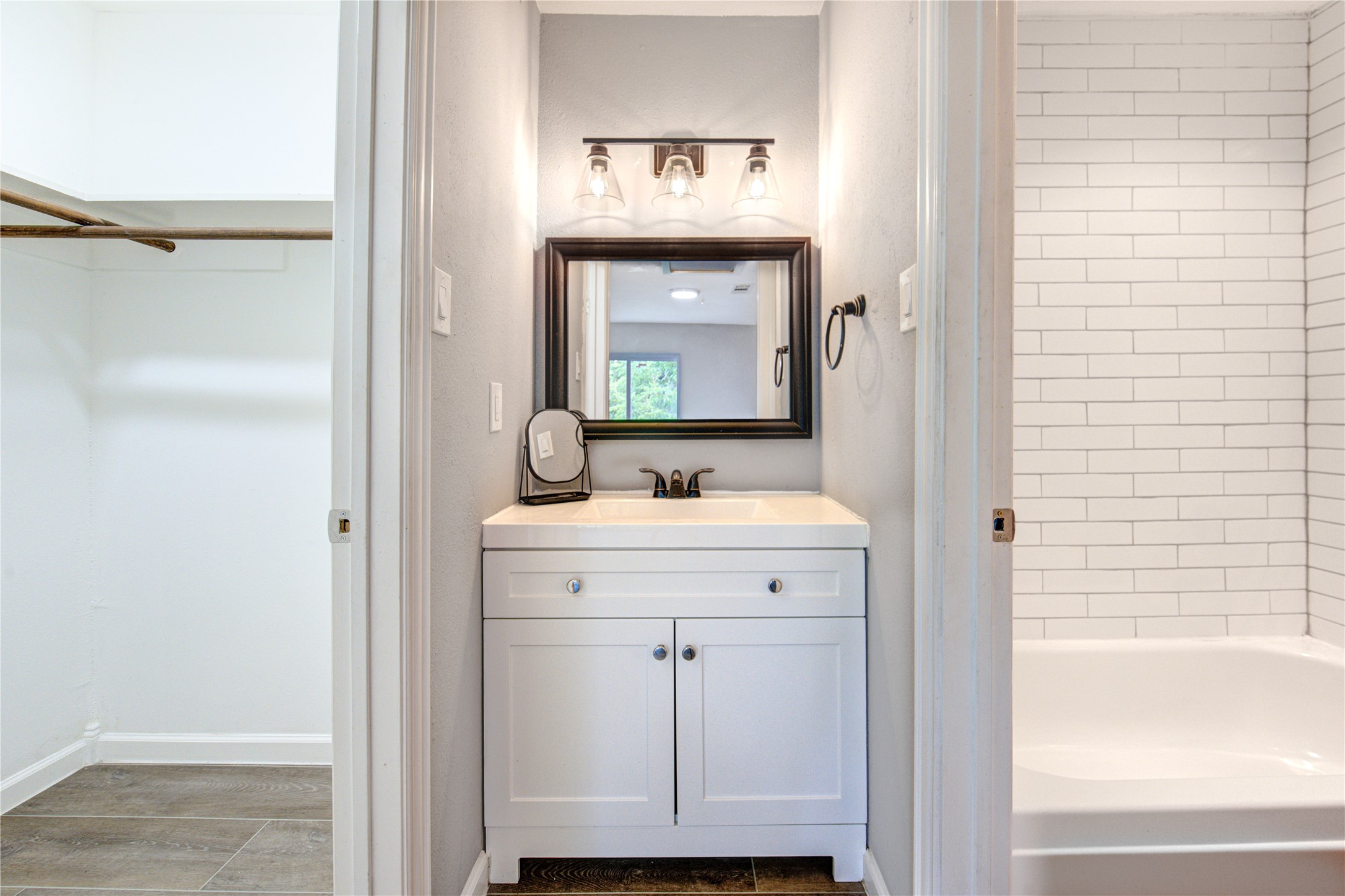 3929 Tanglewilde Street, Unit 3929 Houston, TX 77063 - Photo 30 of 44 a bathroom with a sink a mirror and a window