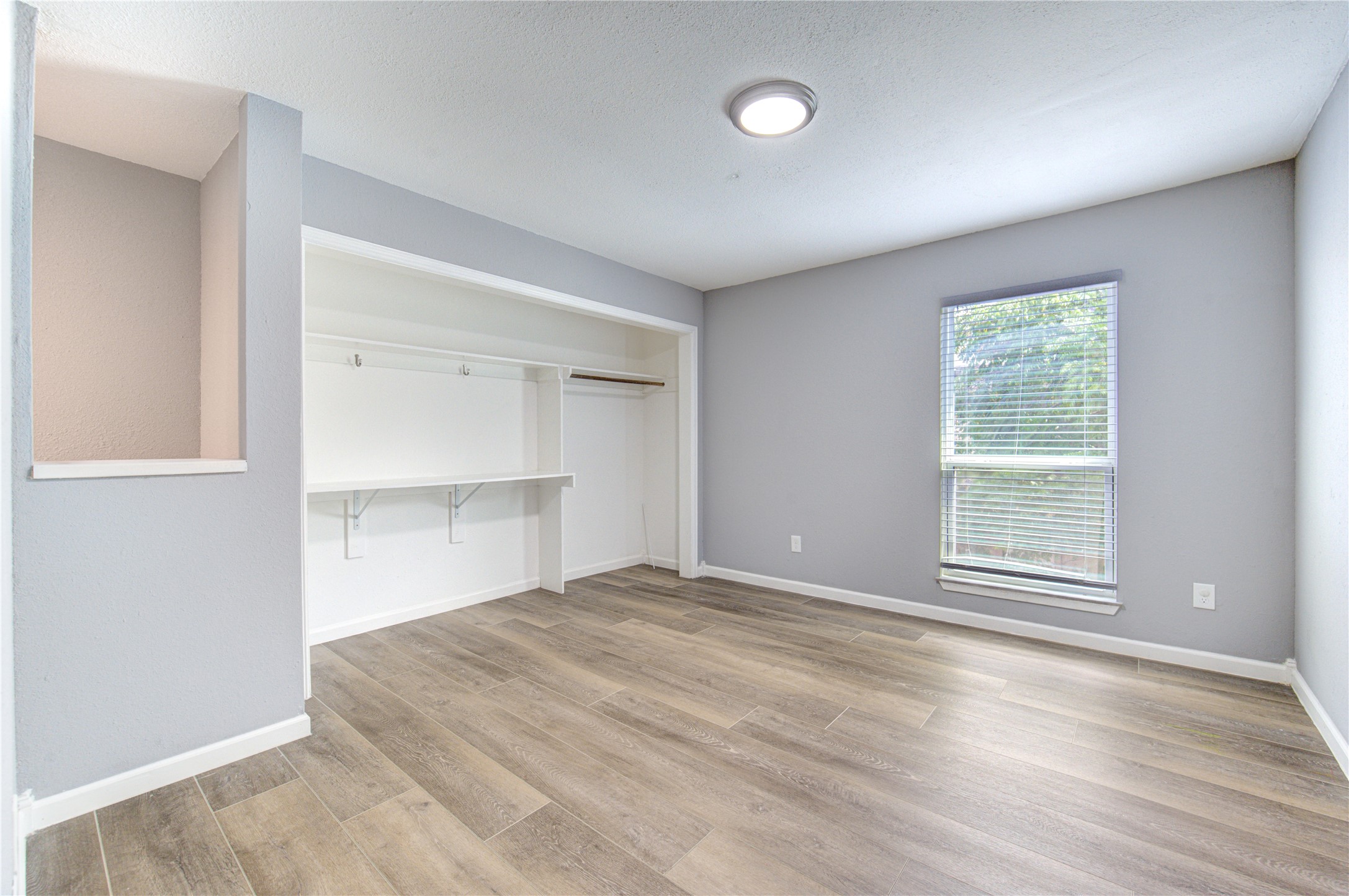 3929 Tanglewilde Street, Unit 3929 Houston, TX 77063 - Photo 34 of 44 a view of an empty room with a window and wooden floor