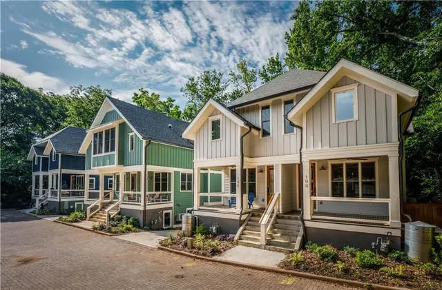 a front view of a house with a garden and plants