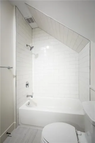 a bathroom with a toilet and a bathtub