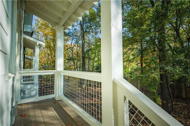 a view of a house with a yard and large trees