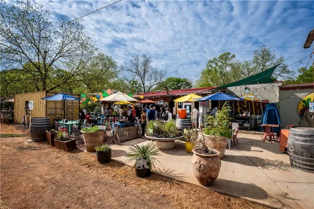 a view of a house with dishwasher and chair under an umbrella