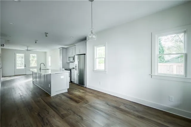 a living room with wooden floors and white walls