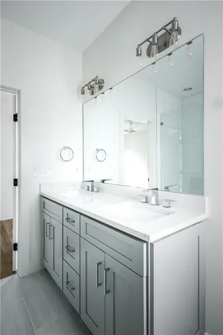 a bathroom with double sink and a mirror
